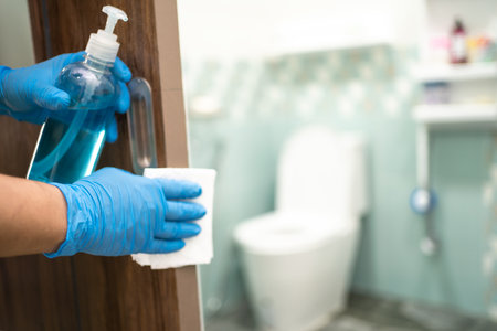 Cleaning door toliet handle at toilet with alcohol and tissue at office and home for protect virus