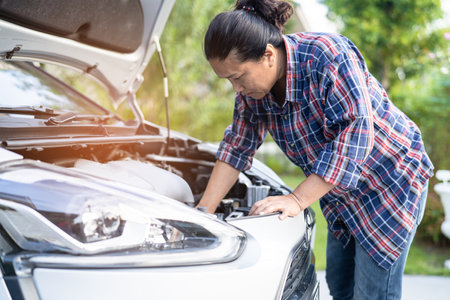 Open hood mechanic engine system to check and repair damage car crash.の写真素材