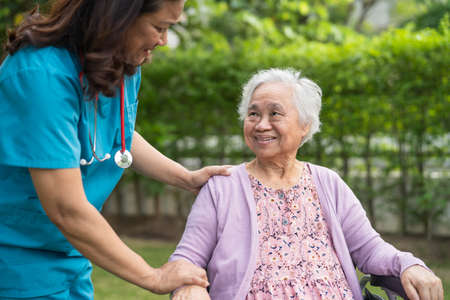 Doctor caregiver help and care Asian senior or elderly old lady woman patient sitting on wheelchair...