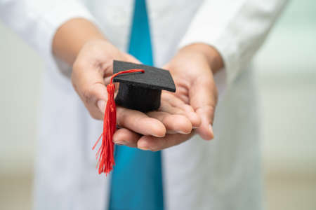 Asian doctor study learn with graduation gap hat in hospital ward, clever bright genius education...
