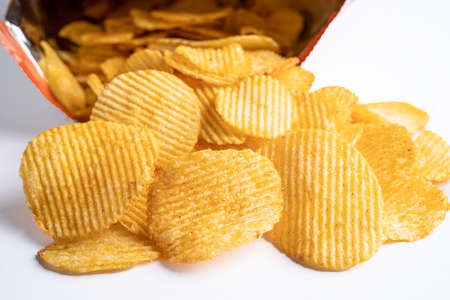 Potato chips, delicious BBQ seasoning spicy for crips, thin slice deep fried snack fast food in open bag.の写真素材