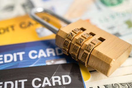 Credit card with password key lock security on US dollar background.