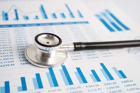 Stethoscope on charts and graphs spreadsheet paper, Finance, Account, Statistics, Investment, Analytic research data economy and Business company concept.の写真素材