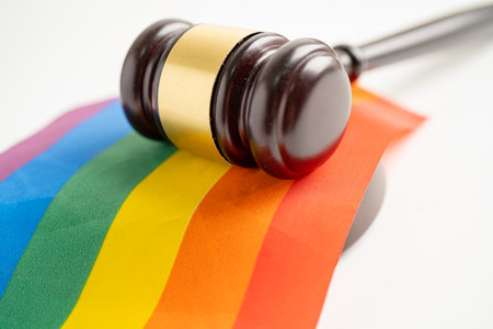Gavel for judge lawyer on rainbow flag, symbol of LGBT pride month celebrate annual in June social of gay, lesbian, bisexual, transgender, human rights.の写真素材