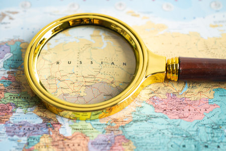 Bangkok, Thailand - August 01, 2022 Russia, Magnifying glass close up with colorful world map
