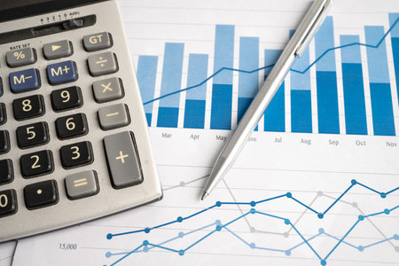 Calculator on chart and graph spreadsheet paper. Finance development, Banking Account, Statistics,...