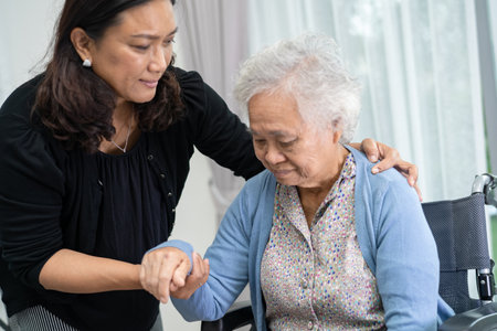 Caregiver help and care Asian senior or elderly old lady woman patient sitting on wheelchair at hospital, healthy strong medical concept.の写真素材