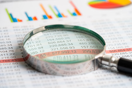 Magnifying glass on charts graphs paper. Financial development, Banking Account, Statistics,...