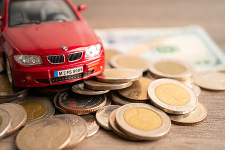 Bangkok, Thailand, June 1, 2022 Car on coins and calculator Car loan, Finance, saving money, insurance and leasing time concept.のeditorial素材