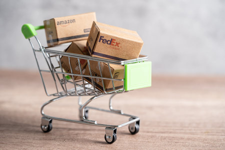 Bangkok, Thailand - September 26, 2022 Shopping cart with DHL Amazon express packing box, import export online exchange investment business.のeditorial素材