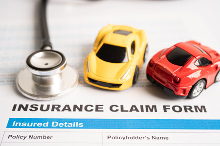 Stethoscope on Insurance claim accident car form, Car loan, insurance and leasing time concepts.の写真素材