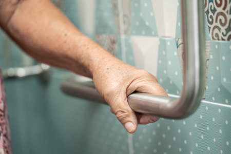 Asian senior or elderly old lady woman patient use toilet bathroom handle security in nursing hospital ward, healthy strong medical concept.の写真素材