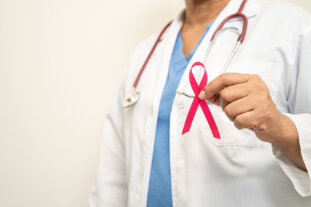 Breast cancer, Asian doctor woman with pink ribbon, symbol of World Breast Cancer Day.の写真素材