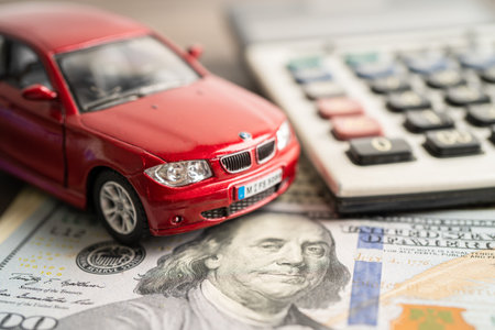 BANGKOK, THAILAND - FEBRUARY 18, 2022, Car on US dollar and calculator; Car loan, Finance, saving money, insurance and leasing time concepts.のeditorial素材