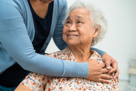 Caregiver help Asian elderly woman patient with love, care, encourage and empathy at nursing hospital, healthy strong medical concept.の写真素材