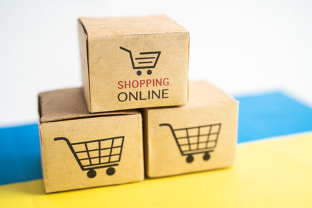 Box with shopping online cart and Ukraine flag, Import Export Shopping online or commerce finance delivery service store product shipping, trade, supplier concept.の写真素材
