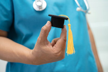 Asian doctor study learn with graduation gap hat in hospital ward, clever bright genius education medicine concept.の写真素材