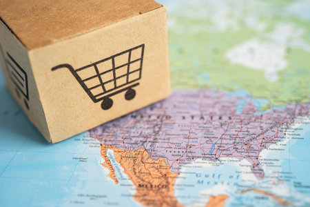 BANGKOK, THAILAND MARCH 1, 2023 Box with shopping online cart logo on USA America map, Import Export Shopping online or commerce finance delivery shipping, trade, supplier concept.のeditorial素材