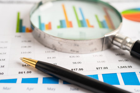 Magnifying glass on graph paper. Financial development, Banking Account, Statistics, Investment...