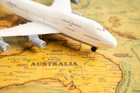 Bangkok, Thailand, March 1, 2023 Airplane on Australia world map, international flights to travel transportation concept.のeditorial素材