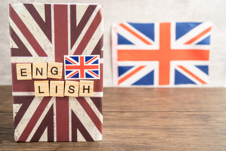 Word English on book with United Kingdom flag, learning English language courses concept.の写真素材