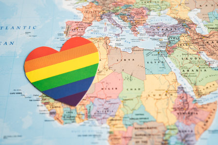 Bangkok, Thailand, June 1, 2022 Rainbow color heart on globe world map background, LGBT pride month celebrate annual in June, symbol of gay, lesbian, bisexual, transgender, human rights and peace.のeditorial素材