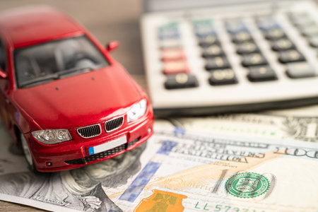 BANGKOK, THAILAND - FEBRUARY 18, 2022, Car on US dollar and calculator; Car loan, Finance, saving money, insurance and leasing time concepts.のeditorial素材