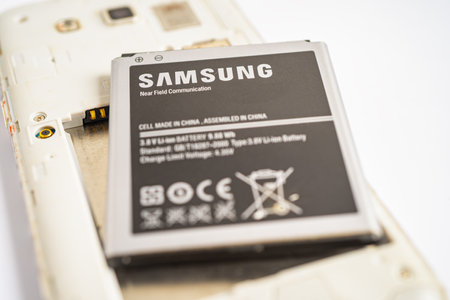 BANGKOK,THAILAND. MAY 1 2023 technician repairing and insert battery for Smartphone SAMSUNG.