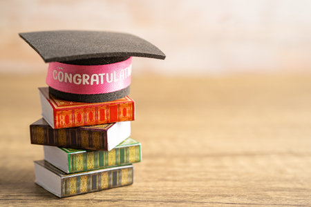 Graduation hat on book with copy space, learning university education concept.の写真素材