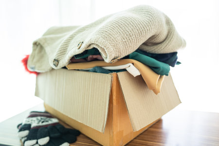 Donation box with used clothes at home to support help for poor people in the world.の写真素材