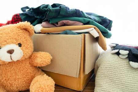 Donation box with used clothes at home to support help for poor people in the world.の写真素材