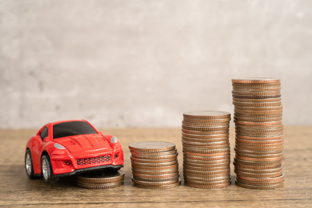 Bangkok, Thailand, July 1, 2022 Car and coins, Car loan, Finance, saving money, insurance and leasing time concepts.のeditorial素材