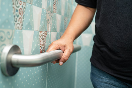 Asian elderly woman use bathroom handle security in toilet, healthy strong medical concept.の写真素材