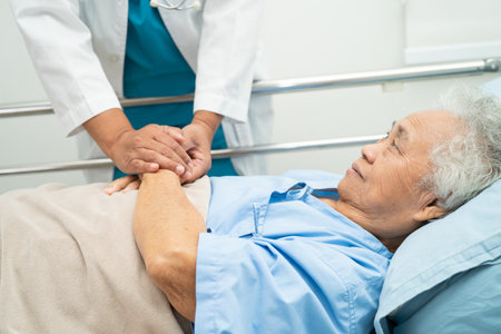 Doctor using stethoscope to checking the patient lie down on a bed in the hospital, healthy strong medical concept.の写真素材
