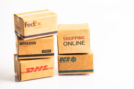 Bangkok, Thailand September 26, 2022 Shopping cart with DHL Amazon and FedEx express packing box, import export online exchange investment business.のeditorial素材