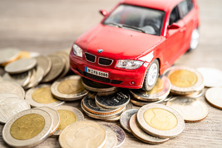 BANGKOK, THAILAND - FEBRUARY 12, 2023, Car on coins background; Car loan, Finance, saving money, insurance and leasing time concepts.のeditorial素材