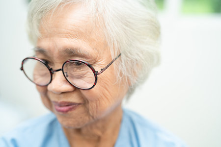 Asian senior woman wearing eyeglasses or vision glasses at home care service.