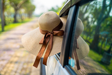 Happy enjoy and freedom in traveling trip and wearing hat outside of window car in summer vacation holiday.の写真素材