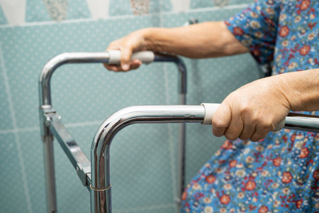 Asian elderly woman use walker in bathroom, handle security in toilet, healthy strong medical.の写真素材
