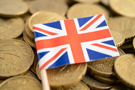 United Kingdom flag on coins money, finance and accounting, banking concept.の写真素材