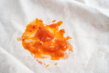 Dirty tomato sauce stain or ketchup on cloth to wash with washing powder, cleaning housework concept.の写真素材