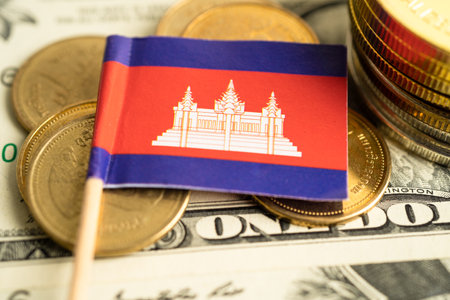Stack of coins with Cambodia flag and US dollar banknotes.の写真素材