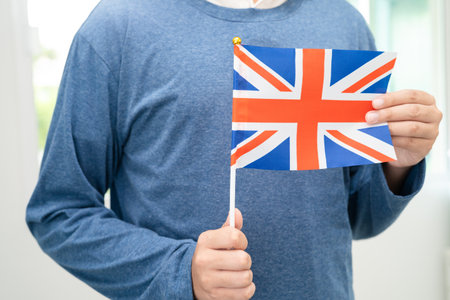 Learn English language, Asian teenage student hold UK flag in course at school.の写真素材