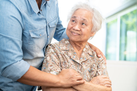 Caregiver help and care Asian senior woman patient with love, encourage and empathy in hospital.の写真素材