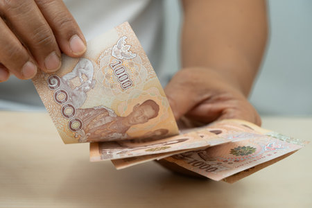 Asian woman holding Thai banknotes money, economy finance exchange trade investment.