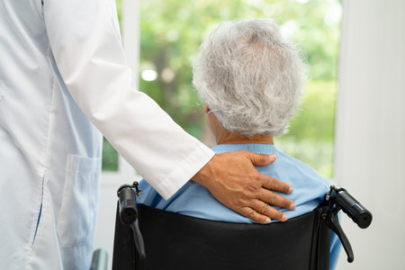 Doctor help and care Asian senior woman on wheelchair at hospital.の写真素材