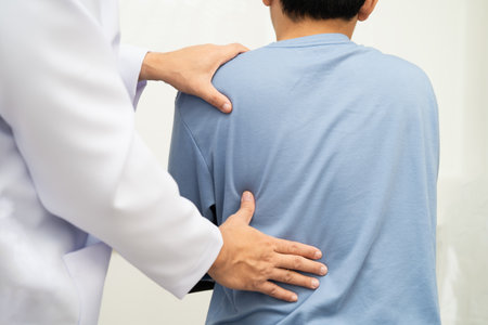 Physical therapy, Asian therapist doctor treat perform pain young man in hospital.