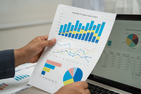 Asian business woman working with financial graph.