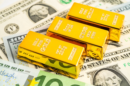Gold bar on US dollar and Euro banknote, economy finance exchange trade investment.の写真素材