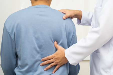 Physical therapy, Asian therapist doctor treat perform pain young man in hospital.